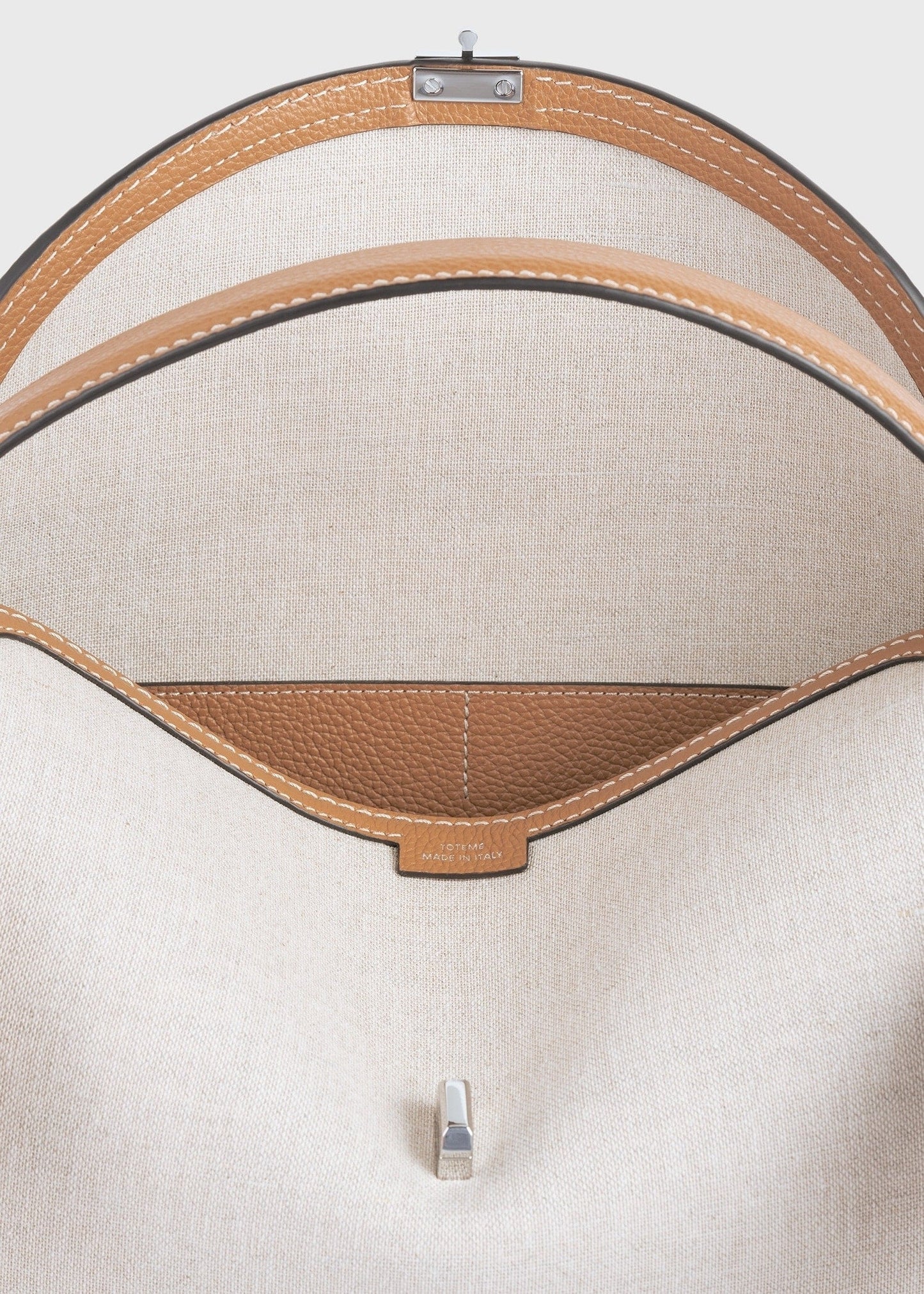 Totême T-Lock Canvas Top Handle in ecru/Tan.